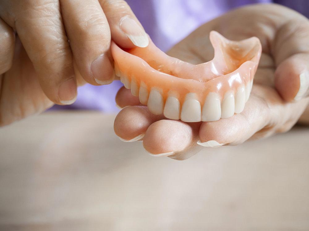 An image of a person holding a denture in Woodland HIlls